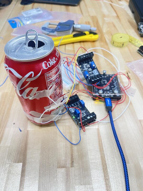 Instrumented pressure vessel test setup with strain gauges, wiring, amplifiers, and data acquisition hardware